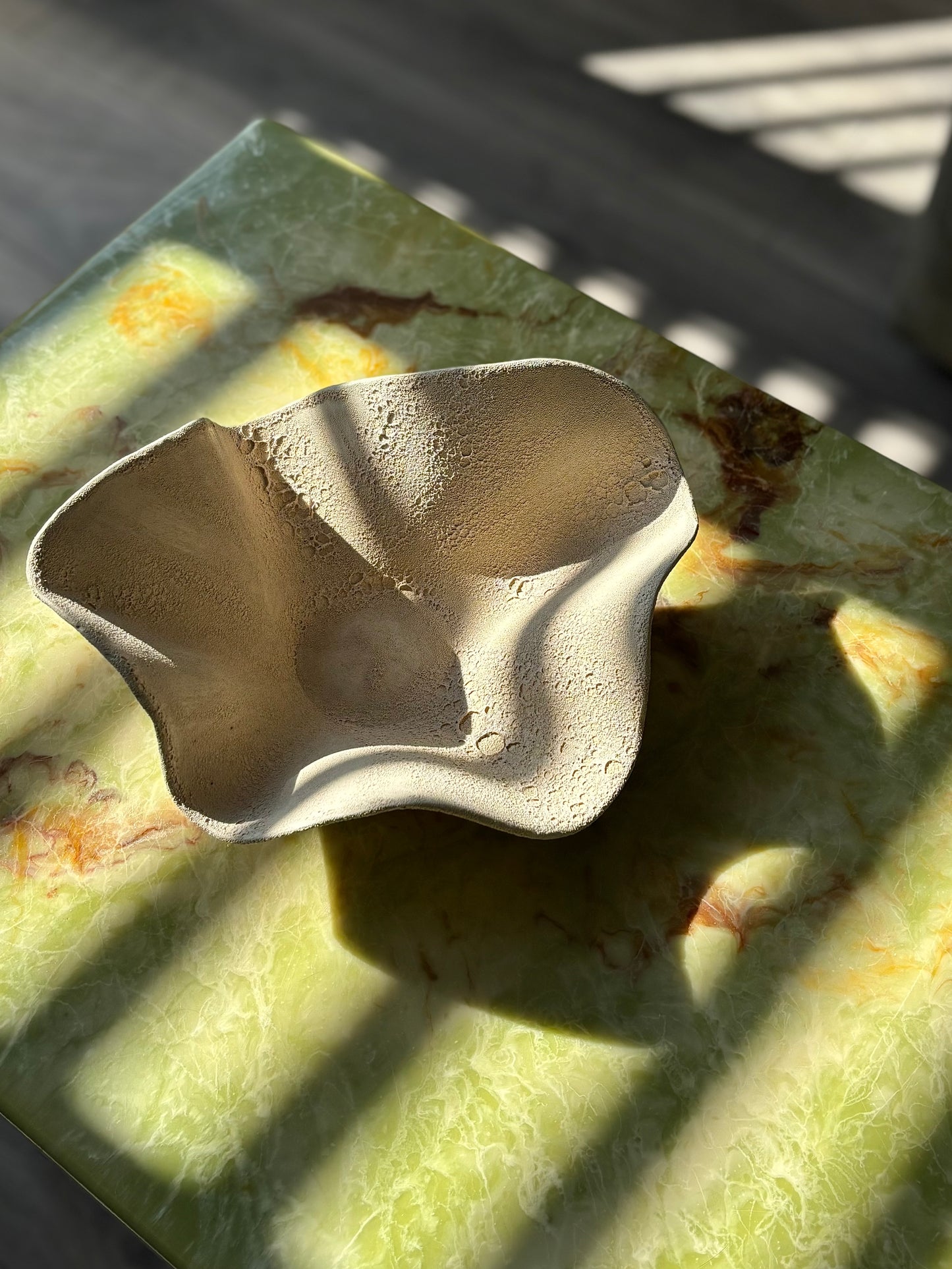 Decorative sculpture in textured stone glaze